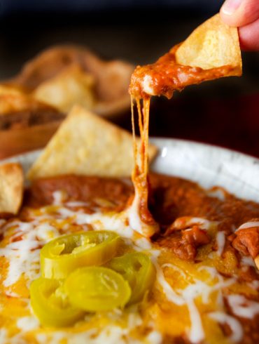 A chip dip into plate of Refried Pinto Beans recipe