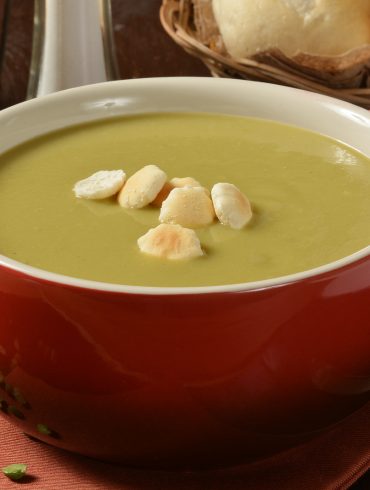 Bowl with handle filled with a serving of split pea soup